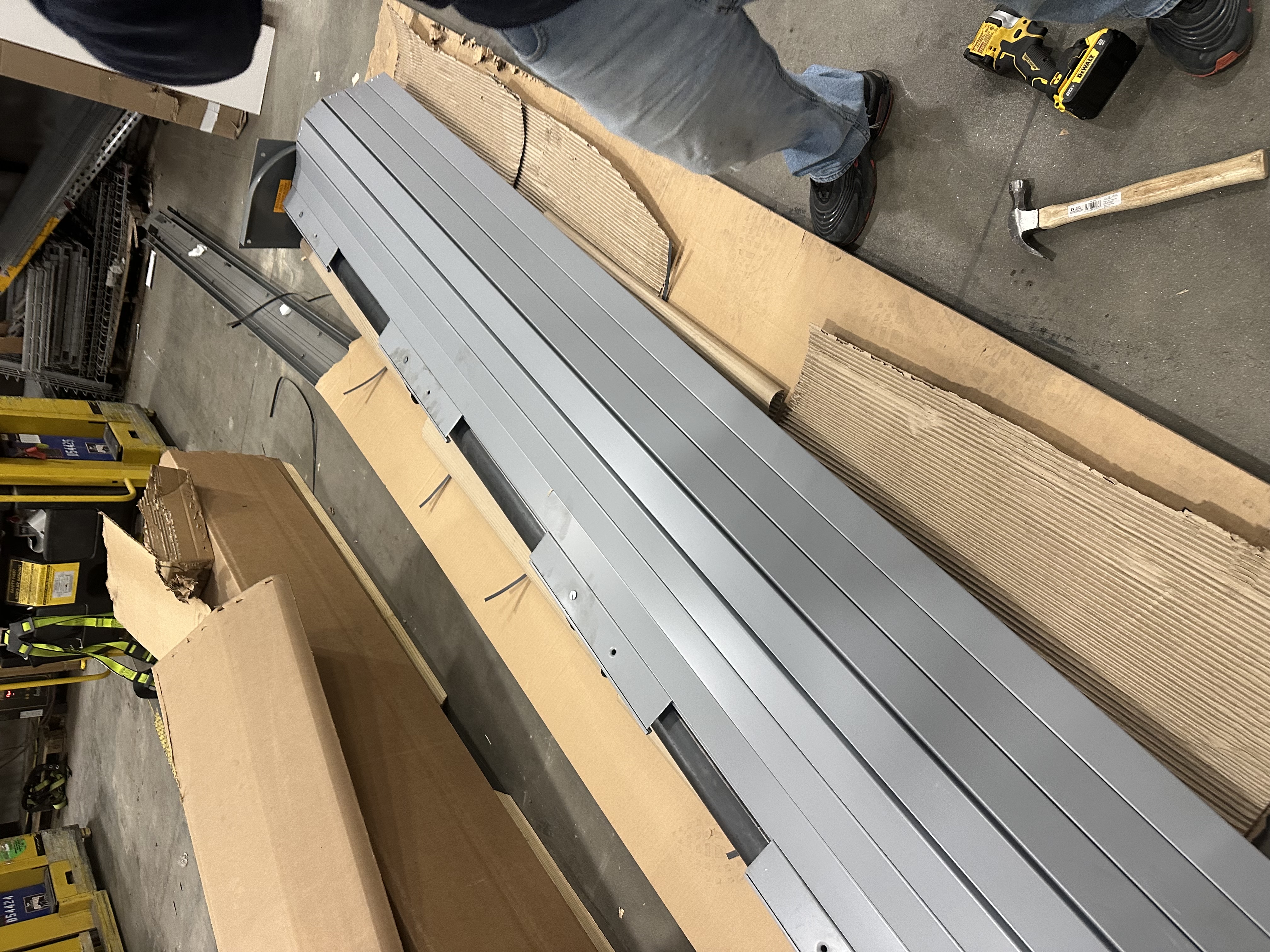 Steel garage door track sections and hardware unboxed and ready for professional installation